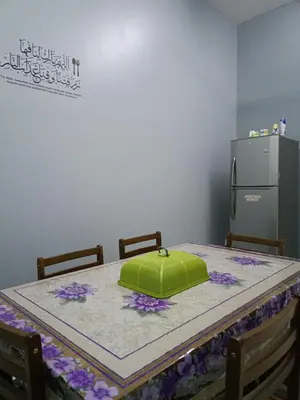 a table with a green box on top of it at Seri Raban Homestay in Kampong Kuala Chegar