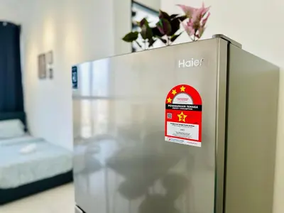 a refrigerator with a sign on top of it at World Class Apartment In Georgetown 3BR in Jelutong