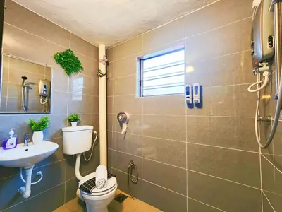 a bathroom with a toilet and a sink at IPOH Rainbow Blissful Villa, Persiaran Halaman Ampang Ipoh in Ipoh