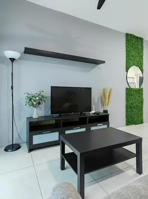 a living room with a black table and a tv at Meritus - Perai, Penang in Perai