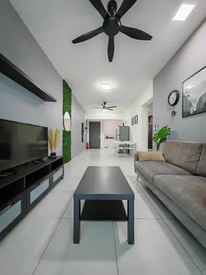 a living room with a couch and a ceiling fan at Meritus - Perai, Penang in Perai