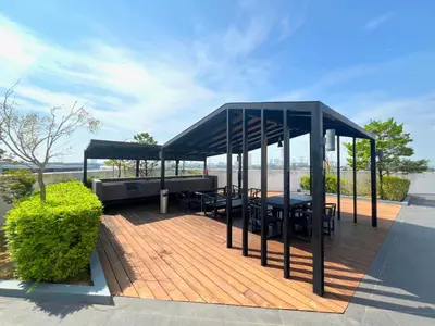 a pavilion with tables and chairs on a wooden deck at Meritus - Perai, Penang in Perai