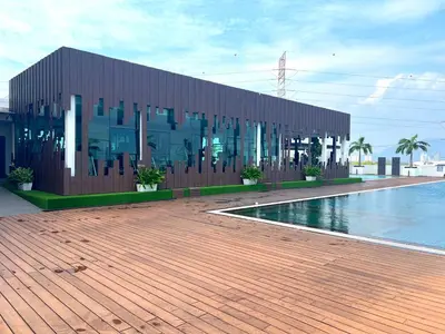 a building with a swimming pool in front of a building at Meritus - Perai, Penang in Perai