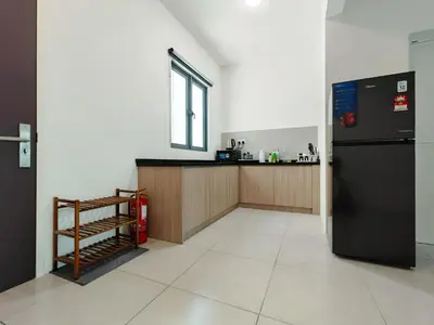 a kitchen with a black refrigerator and a counter at Meritus - Perai, Penang in Perai