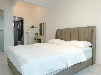 a bedroom with a large bed with white sheets at Meritus - Perai, Penang in Perai