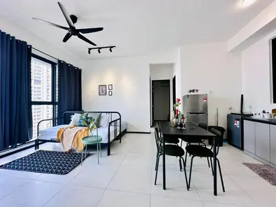 a living room with a bed and a dining room at Familystay Home 3BR-10PAX in Gua Sai