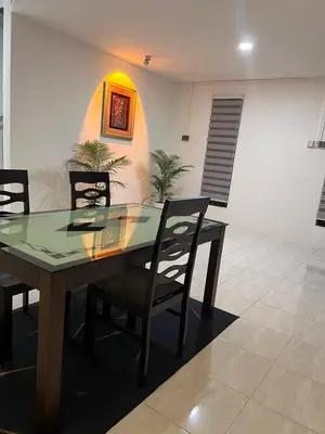a dining room with a glass table and chairs at 23 Inn Kingbed Room with Balcony in Bukit Mertajam