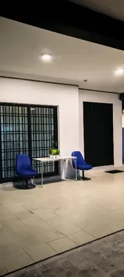 two blue chairs and a table in a room at 23 Inn Kingbed Room with Balcony in Bukit Mertajam