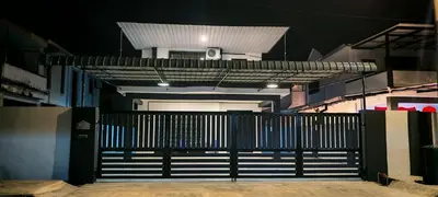 an entrance to a building with a black gate at 23 Inn Kingbed Room with Balcony in Bukit Mertajam