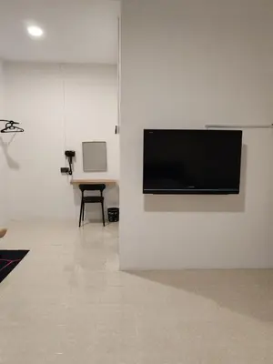 a flat screen tv on a wall in a room at 23 Inn Kingbed Room with Balcony in Bukit Mertajam