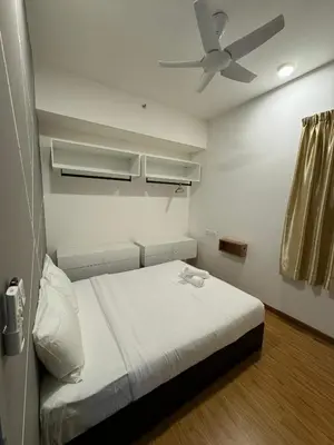 a bedroom with a bed with a ceiling fan at Cozy Comfort- Beacon Executives Suite in George Town