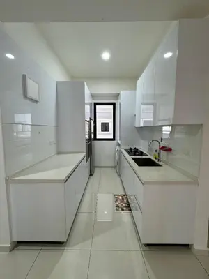 a white kitchen with white cabinets and a sink at Cozy Comfort- Beacon Executives Suite in George Town