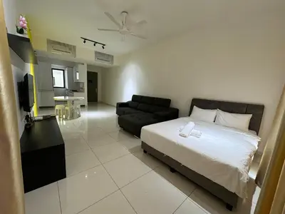 a bedroom with a bed and a living room at Cozy Comfort- Beacon Executives Suite in George Town