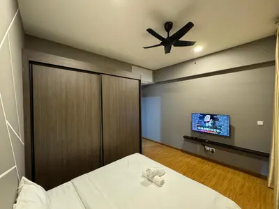 a bedroom with a bed and a ceiling fan at Cozy Comfort- Beacon Executives Suite in George Town