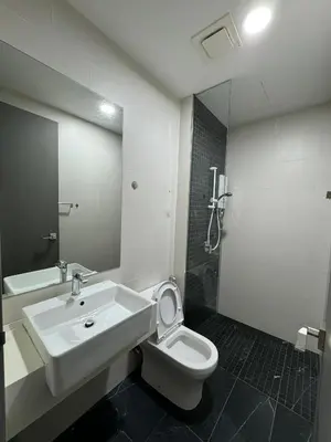 a bathroom with a sink and a toilet and a mirror at Cozy Comfort- Beacon Executives Suite in George Town