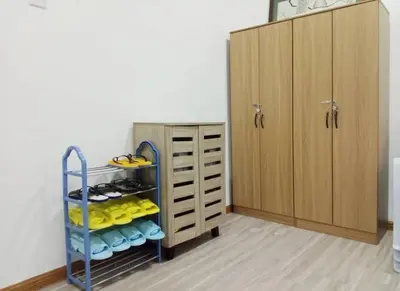 a room with a shelf with shoes and a cabinet at Quintet Cottage in Cameron Highlands