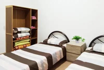 a bedroom with two beds and a closet at Quintet Cottage in Cameron Highlands