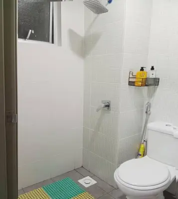 a bathroom with a shower with a toilet in it at Quintet Cottage in Cameron Highlands