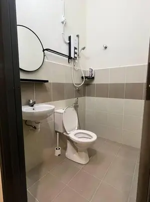 a bathroom with a toilet and a sink at Homestay Taman Banjar Indah, Teluk Intan in Teluk Intan
