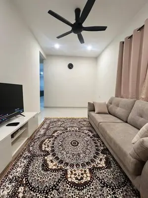 a living room with a couch and a ceiling fan at Homestay Taman Banjar Indah, Teluk Intan in Teluk Intan