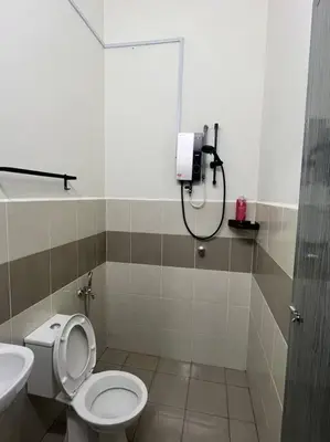 a bathroom with a toilet and a shower at Homestay Taman Banjar Indah, Teluk Intan in Teluk Intan