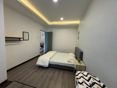 a bedroom with a bed and a tv in a room at AYAAN Comfy Homestay with FREE WiFi in Tanah Rata