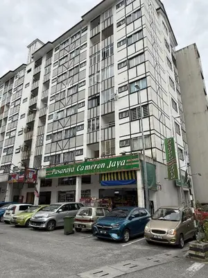 a large building with cars parked in a parking lot at AYAAN Comfy Homestay with FREE WiFi in Tanah Rata