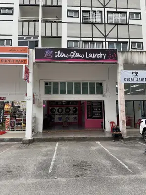 a store with a pink door in a parking lot at AYAAN Comfy Homestay with FREE WiFi in Tanah Rata