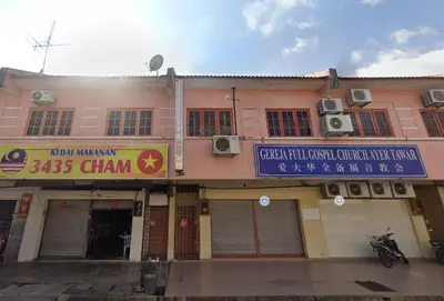 a pink building with a sign on the front of it at Taman Medan Seri Sentosa, Ayer Tawar in Ayer Tawar