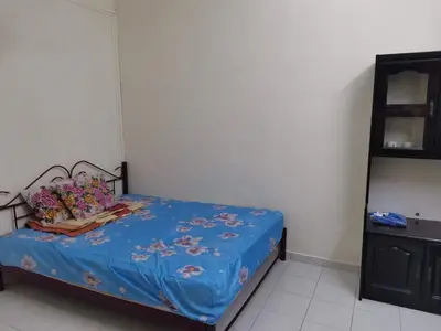 a bedroom with a bed with a blue comforter at Taman Medan Seri Sentosa, Ayer Tawar in Ayer Tawar