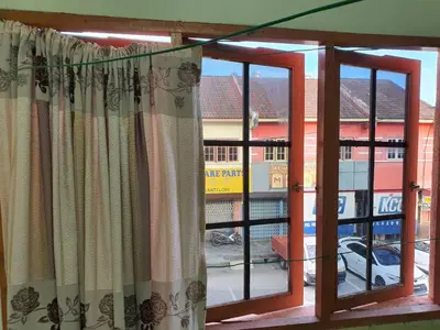 a window with curtains in front of a building at Taman Medan Seri Sentosa, Ayer Tawar in Ayer Tawar