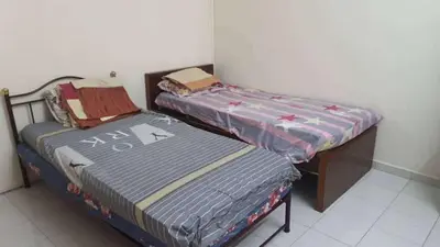 two beds sitting next to each other in a room at Taman Medan Seri Sentosa, Ayer Tawar in Ayer Tawar