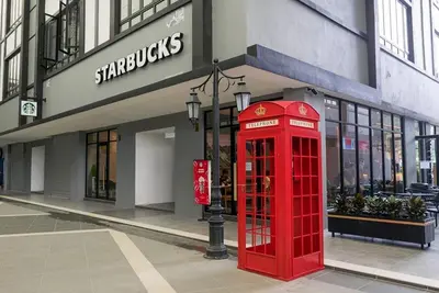 a red phone booth in front of a store at Qaseh Homestay Cameron Highlands 5 in Brinchang