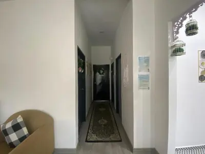 a hallway with a couch and a rug on the floor at Maison Helysa Homestay in Lumut