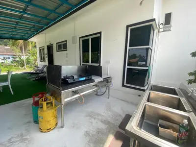 a patio with a table and two sinks at Maison Helysa Homestay in Lumut