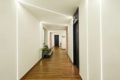 an empty hallway with white walls and wood floors at Merits Hotel Cameron Highlands in Cameron Highlands
