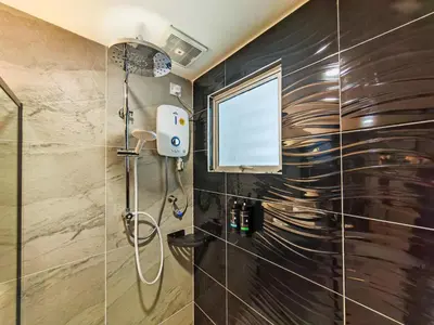 a bathroom with a shower with a glass door at Merits Hotel Cameron Highlands in Cameron Highlands