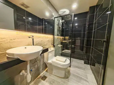 a bathroom with a toilet and a sink and a shower at Merits Hotel Cameron Highlands in Cameron Highlands