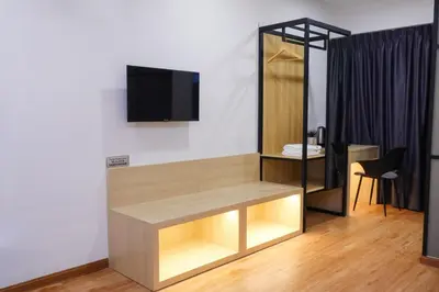 a living room with a tv on a wall at Merits Hotel Cameron Highlands in Cameron Highlands