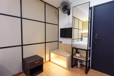 a small room with a bed and a mirror at Merits Hotel Cameron Highlands in Cameron Highlands