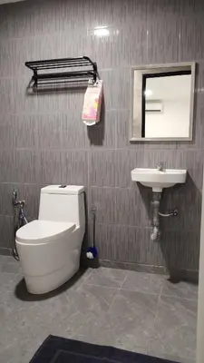 a bathroom with a toilet and a sink at 23 Inn Queenbed Standard Room in Bukit Mertajam