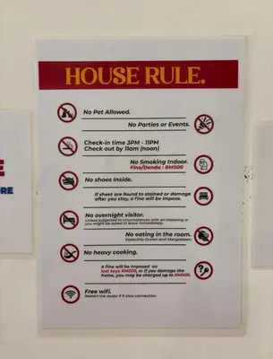 a sign that says house rule on a wall at Cottage Near Lake Garden in Taiping