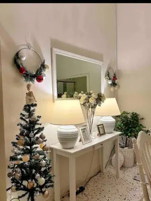 a living room with a christmas tree on a table at Cottage Near Lake Garden in Taiping