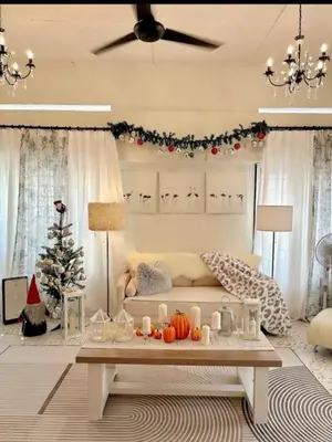 a living room with a couch and a christmas tree at Cottage Near Lake Garden in Taiping