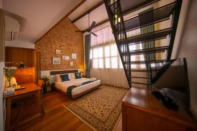 a small bedroom with a bed and a window at Sweet Cili Boutique Hotel in George Town