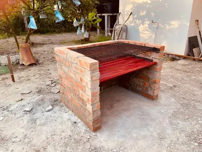 a brick bench sitting on top of a brick fireplace at Inap Desa R'Sawit Pintu A in Sekincan