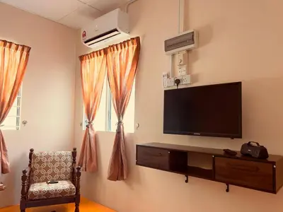 a living room with a flat screen tv on a wall at Inap Desa R'Sawit Pintu A in Sekincan