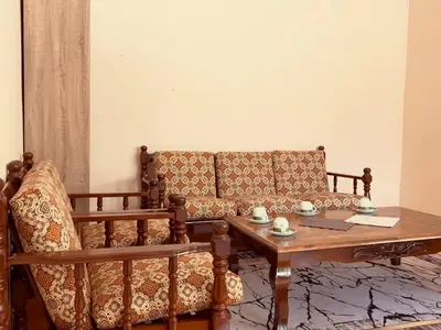 a living room with a couch and a table at Inap Desa R'Sawit Pintu A in Sekincan