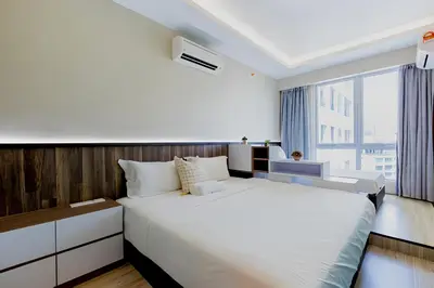 a bedroom with a large white bed and a window at Mansion One l 5pax Studio l Seaview & Cityview l Georgetown l by PerfectSweetHome in George Town