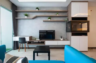 a living room with a blue couch and a tv at Mansion One l 5pax Studio l Seaview & Cityview l Georgetown l by PerfectSweetHome in George Town